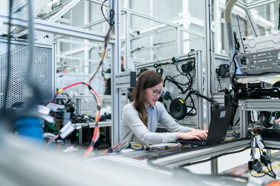 A specialist working on production equipment